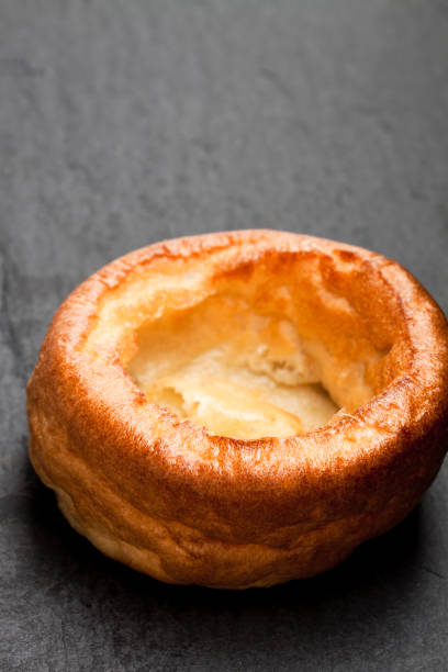 yorkshire  pudding isolated on black stone background - yorkshire pudding imagens e fotografias de stock