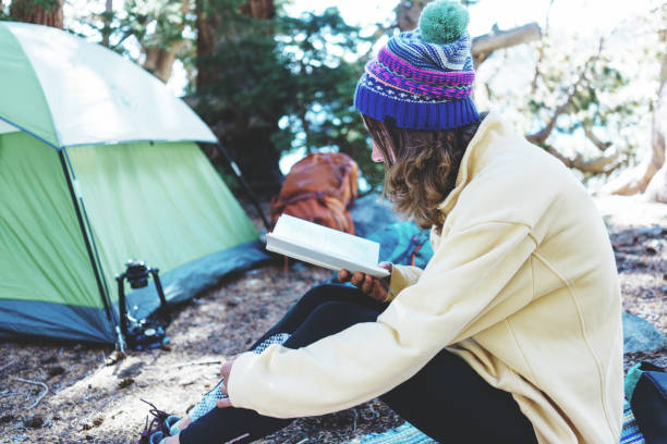 istock Hiking woman reading book in the forest 887236328