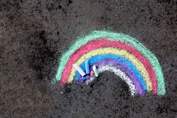 chalk drawing on asphalt: colorful rainbow