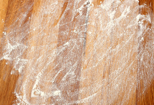 istock white flour on rustic wooden table, top view 887243454