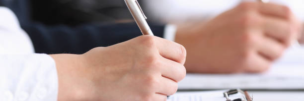 istock Group of people hold silver pen ready to make 887246002