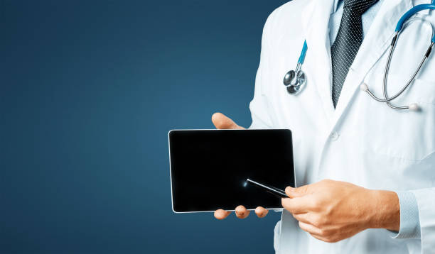 istock Doctor Using Digital Tablet In Consultation With Patient On Blue Background With Space 887246166