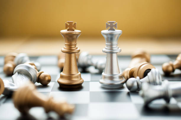 istock Golden and silver king chess versus on chess board game.business Leadership concept. 887246536