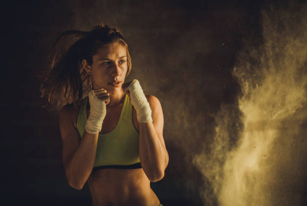 Young female athlete in motion during a kick-boxing training.