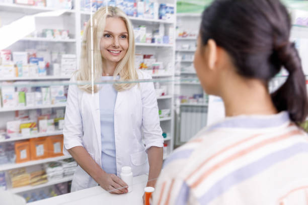 istock pharmacist and customer in drugstore 887246714