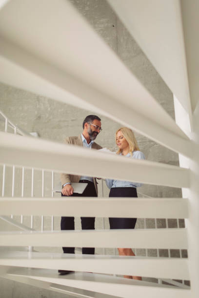 istock Business people on Staircase In Modern Office 887246824