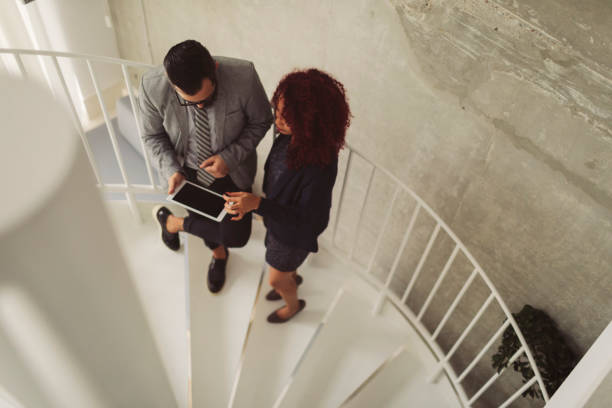 istock Business people on Staircase In Modern Office 887246960