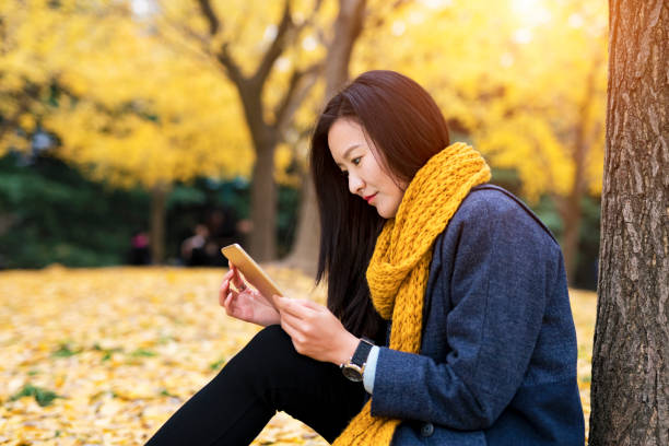 istock Woman sittinging in gingko leafs 887249972