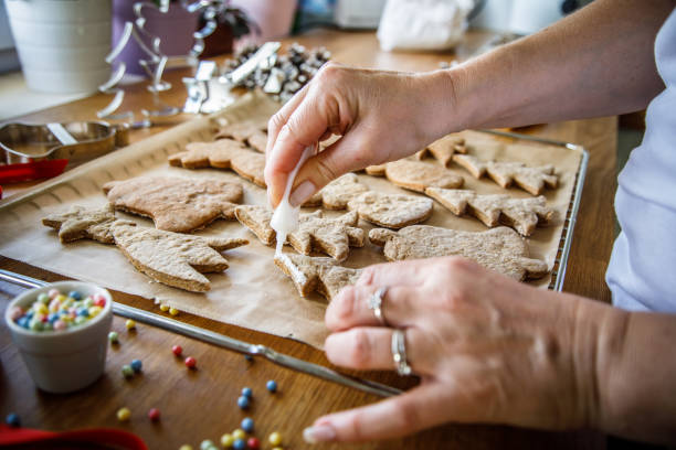 istock Woman making Christmas gingerbread cookies in kitchen 887250374