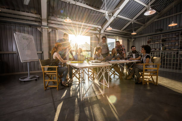 istock Group of happy multi-tasking freelancers working at modern office. 887259978