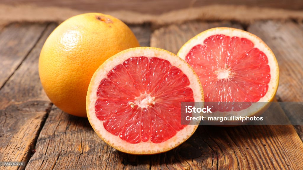 grapefruit on wood background Grapefruit Stock Photo