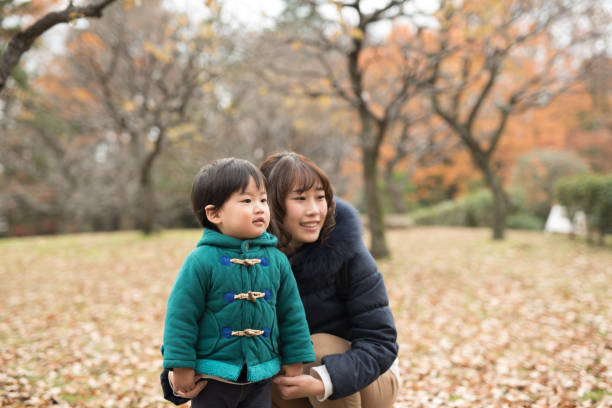 istock mother, son, and autumn leaves 887266142