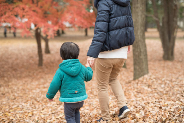 istock mother, son, and autumn leaves 887266260