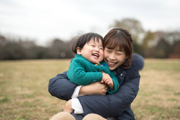 istock Mother embracing her child on the grass 887270240