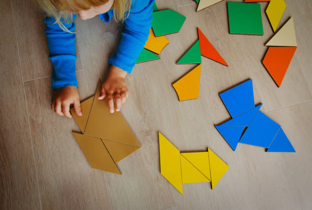 istock little girl playing with puzzle 887270262