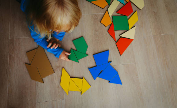 istock little girl playing with puzzle 887270356