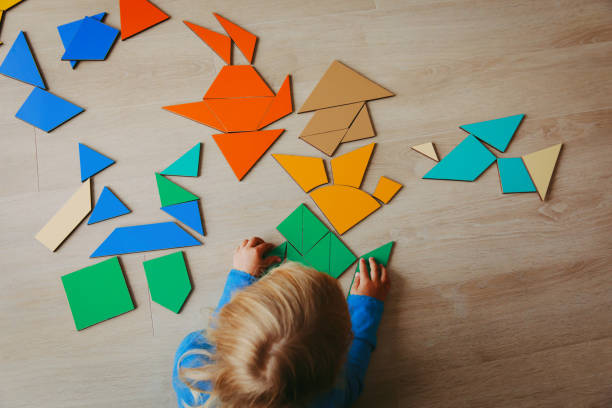 istock little girl playing with puzzle 887270522