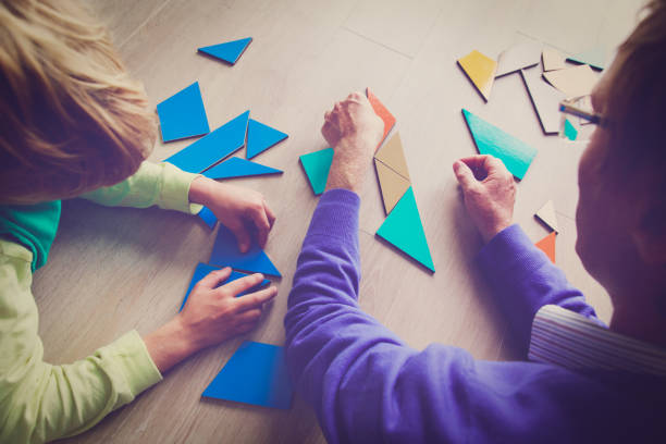 istock teacher and child playing with geometric shapes 887270592