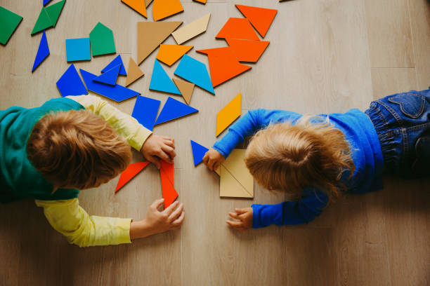 istock kids playing with puzzle, education concept 887270750