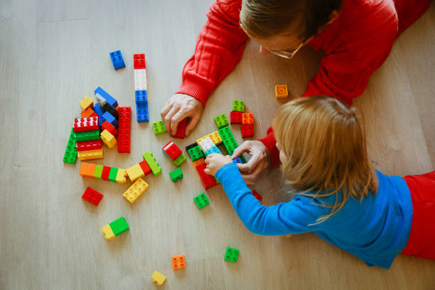 istock teacher and child playing with plastic blocks 887272854