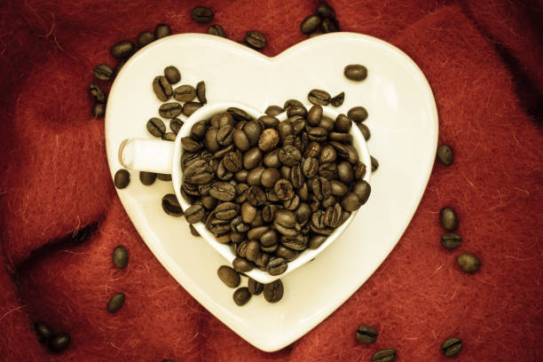istock Heart shaped cup with a coffee beans. 887275776