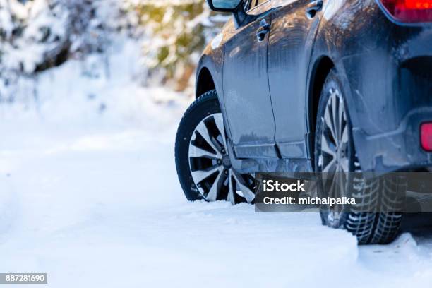 Winter Tires Black Suv Car Rear View On Snowy Forest Road Winter Conditions Stock Photo - Download Image Now