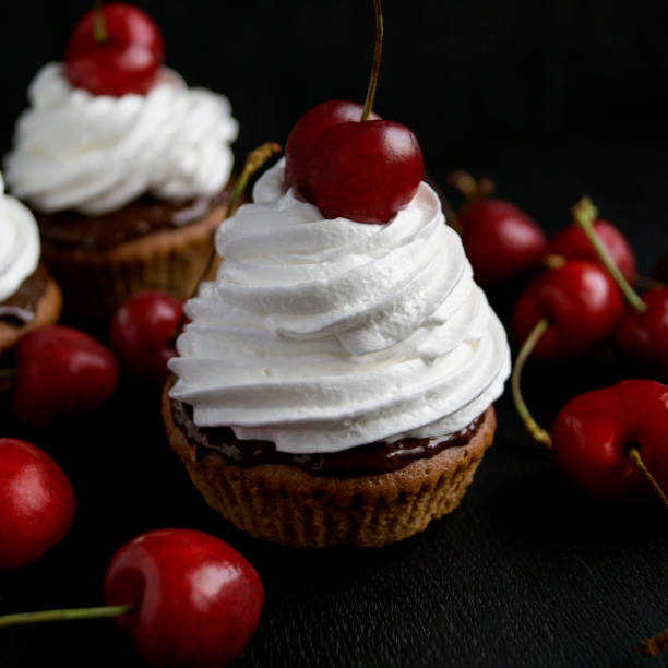 istock homemade cakes with cherries on a black background 887281936