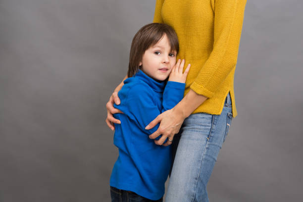istock Sad little child, boy, hugging his mother at home, isolated image 887288100