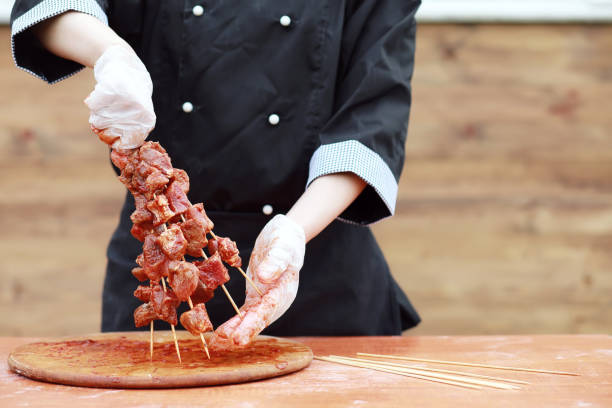 istock The cook cuts meat for cooking barbecue 887291944