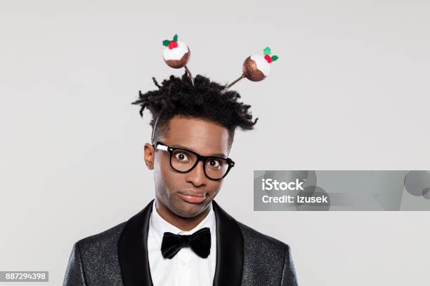 Portrait Of Displeased Elegant Man Wearing Christmas Headband Stock Photo - Download Image Now