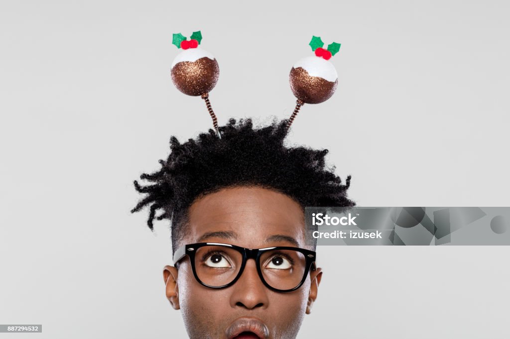 Funny portrait of surprised nerdy man wearing christmas headband Funny portrait of surprised nerdy young man wearing Christmas headband. Close up of face. 25-29 Years Stock Photo