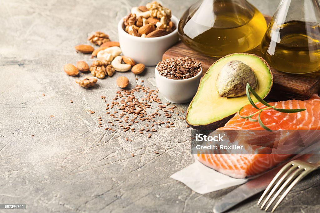 Healthy fats in nutrition. Healthy fats in nutrition - salmon, avocado, oil, nuts. Concept of healthy food Fat - Nutrient Stock Photo