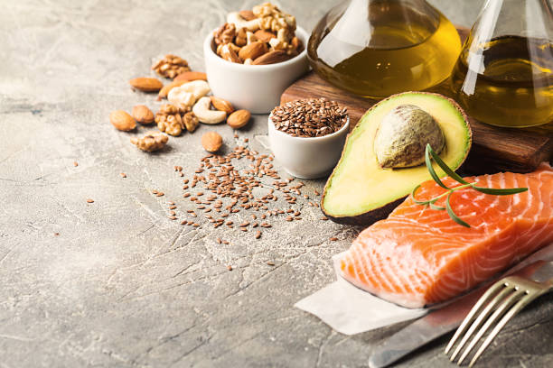 Healthy fats in nutrition. Healthy fats in nutrition - salmon, avocado, oil, nuts. Concept of healthy food fat nutrient stock pictures, royalty-free photos & images