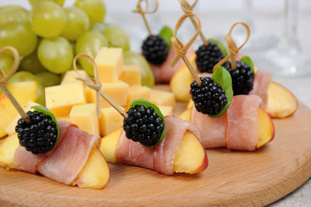 istock Canape from peach with dried ham and blackberries 887297986