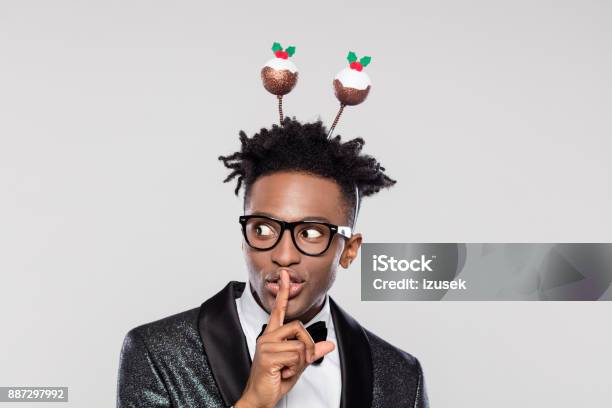Funny Portrait Of Shushing Elegant Man Wearing Christmas Headband Stock Photo - Download Image Now