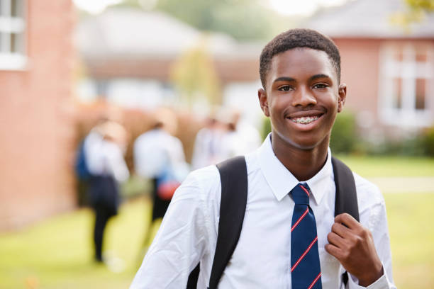 Portrait Of Male Teenage Student In Uniform Outside Buildings Portrait Of Male Teenage Student In Uniform Outside Buildings teenage boys stock pictures, royalty-free photos & images