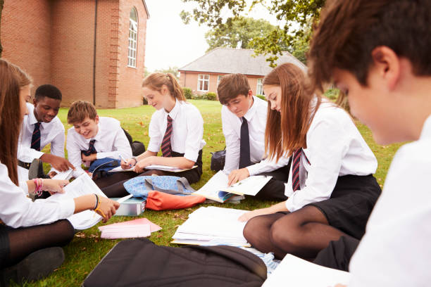 istock Teenage Students In Uniform Working On Project Outdoors 887302434