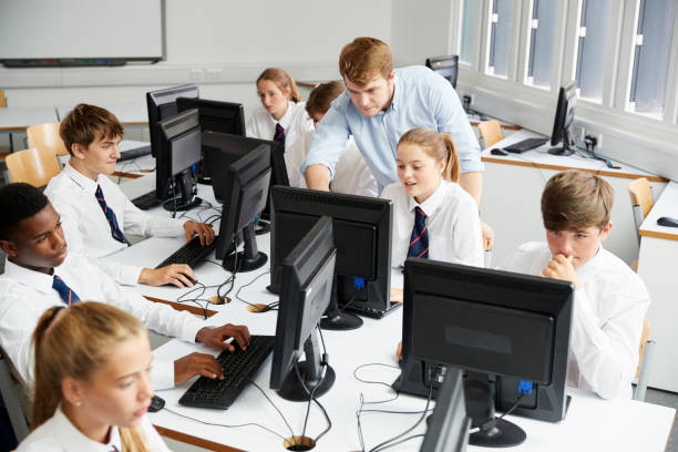 Teenage Students Wearing Uniform Studying In IT Class Teenage Students Wearing Uniform Studying In IT Class independent school education stock pictures, royalty-free photos & images