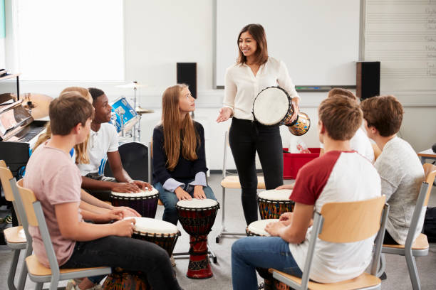 Teenage Students Studying Percussion In Music Class Teenage Students Studying Percussion In Music Class drum percussion instrument stock pictures, royalty-free photos & images