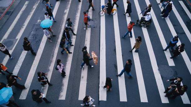 istock Pedestrian people cross a road in rainy day 887303478