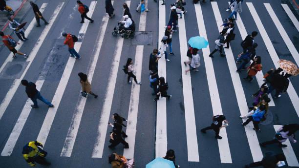 istock Pedestrian people cross a road in rainy day 887303490