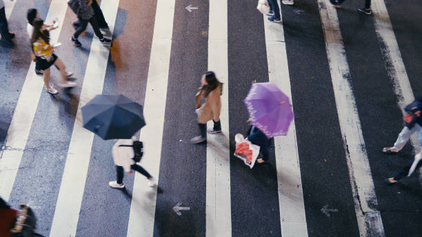 istock Pedestrian people cross a road in rainy day 887304592