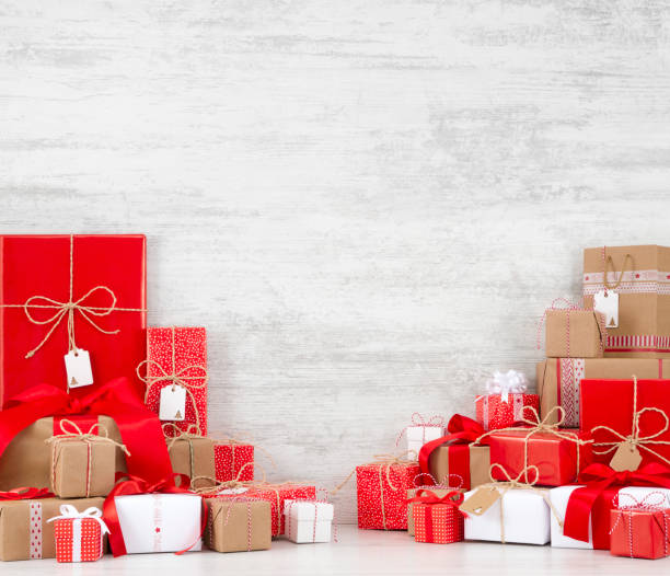 istock Christmas Gift Boxes on White Wooden Background 887307112