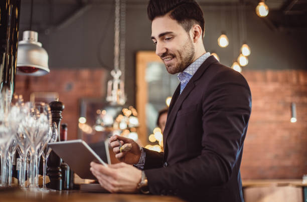 istock Businessman Working in a Cafeteria With Tablet 887309832