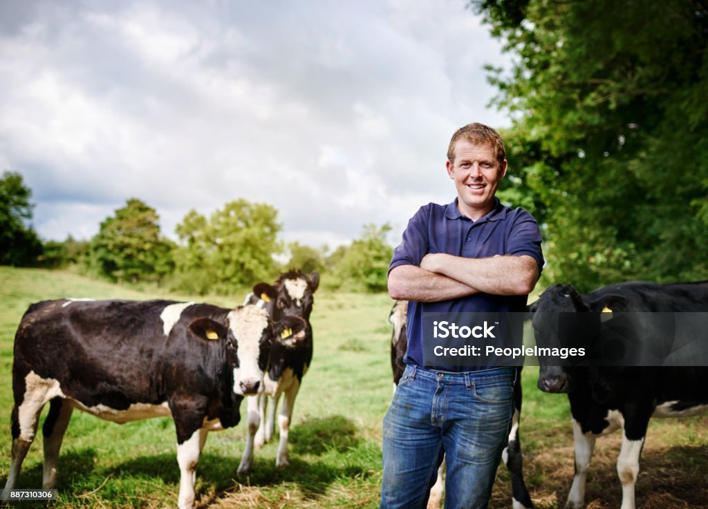 Home is where my cows are Portrait of a male farmer standing with his arms folded on his dairy farm Farmer Stock Photo