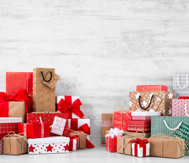 istock Christmas Gifts on White Wooden Table 887312090