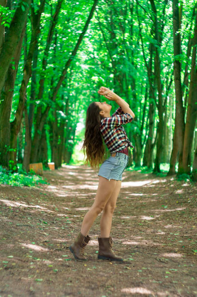 istock Young beautiful girl in the park 887312266