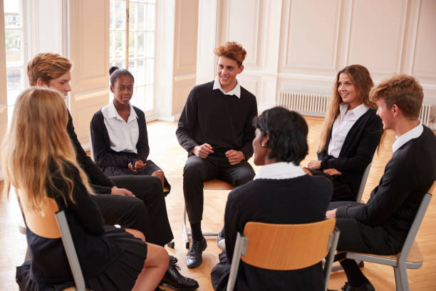 istock Group Of Teenage Students Having Discussion In Class Together 887313228