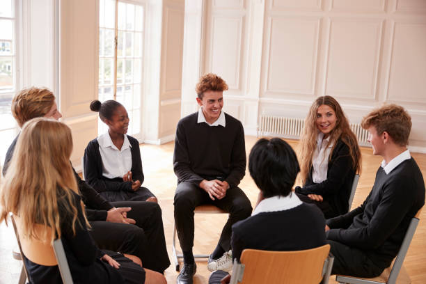 istock Group Of Teenage Students Having Discussion In Class Together 887313230