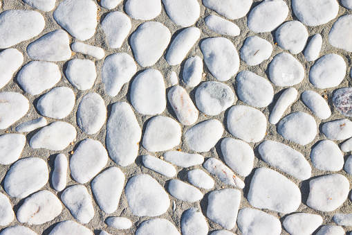 Detail of a pebble floor with white polished stone